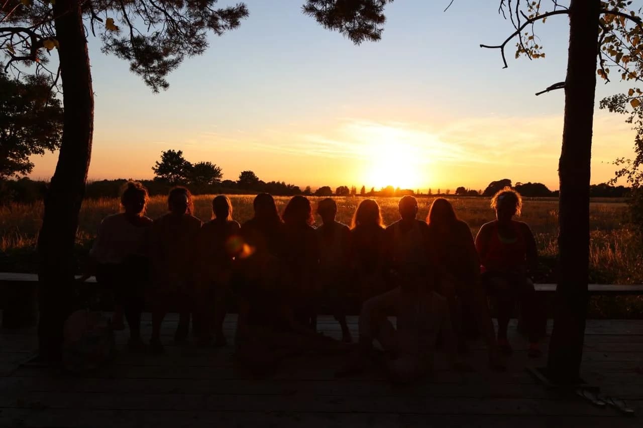 Inner Circle community sitting together watching the sunset
